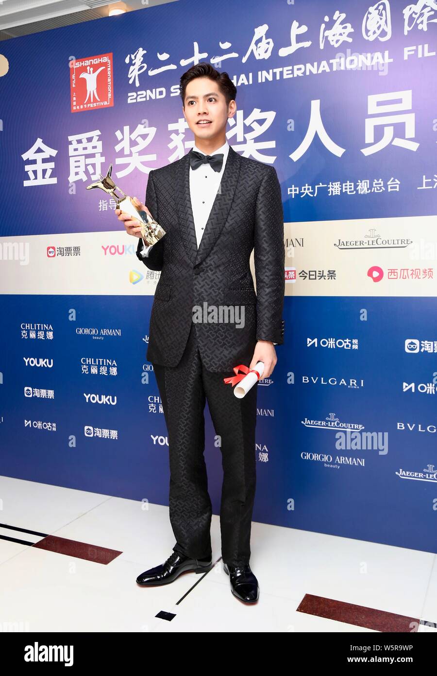 Japanese singer and actor Ryota Katayose poses with trophy after the