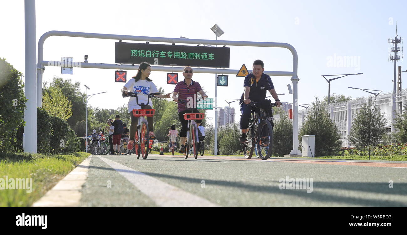 Local residents ride bikes on the first bicycle-only road, which is expected to ease traffic in the area between Huilongguan, in Beijing, China, 31 Ma Stock Photo
