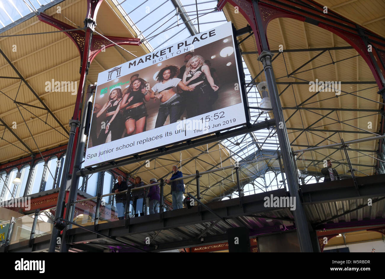 LCD advertising in Roof Bolton Market Place converted into a modern shopping mall while retaining the Victorian ironwork of the original Market Hall Stock Photo