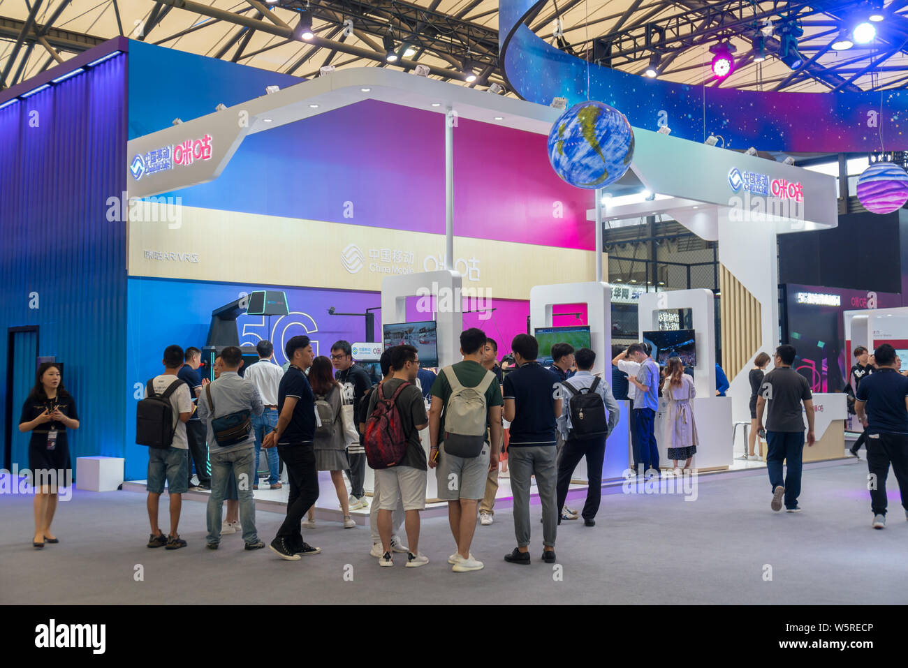 People visit the stand of China Mobile featuring 5G network during the 2019 Mobile World Congress (MWC) in Shanghai, China, 26 June 2019. Chinese tele Stock Photo