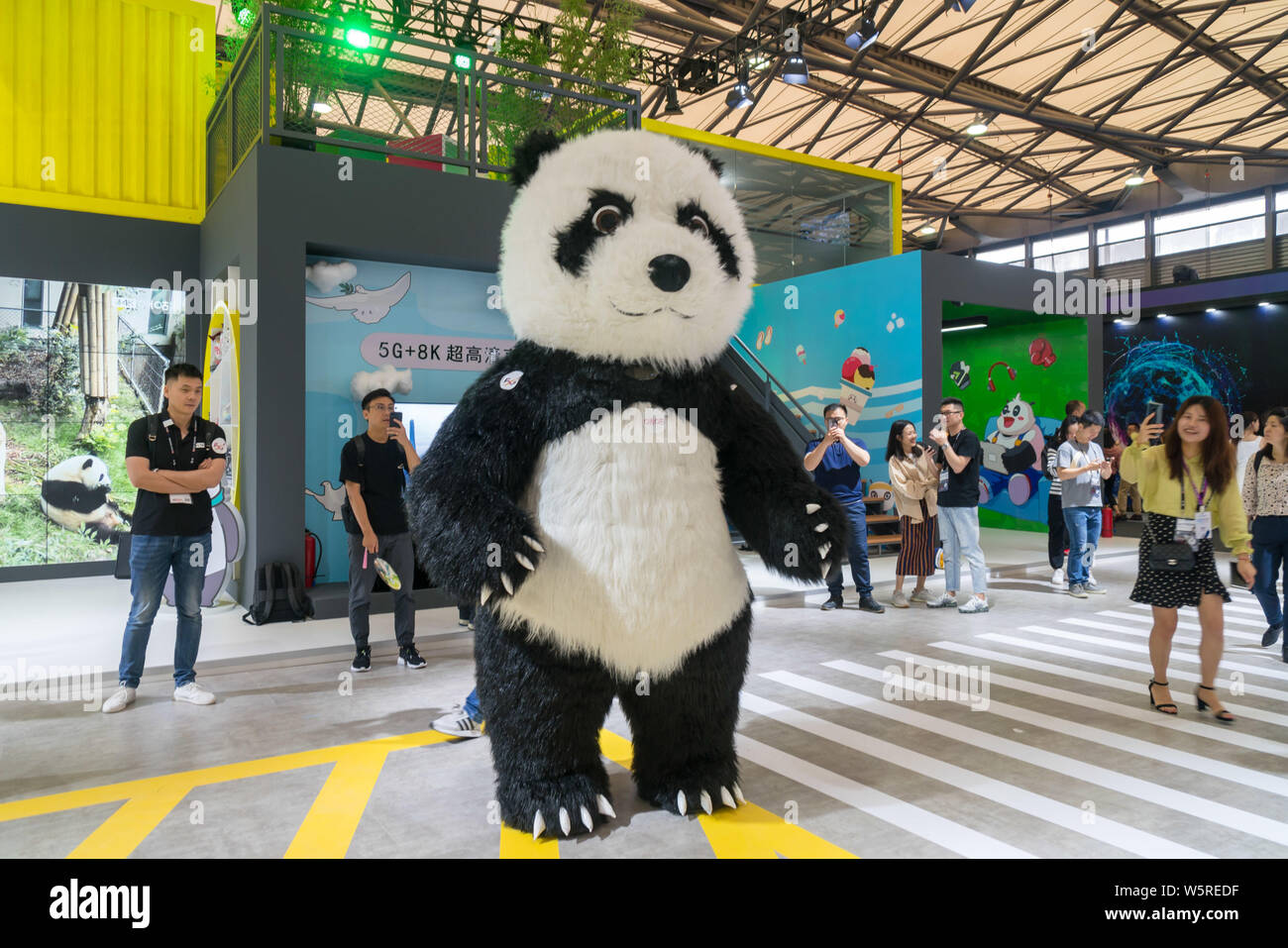 A Chinese worker dressed in giant panda costumes poses during the 2019 Mobile World Congress (MWC) in Shanghai, China, 26 June 2019. Stock Photo