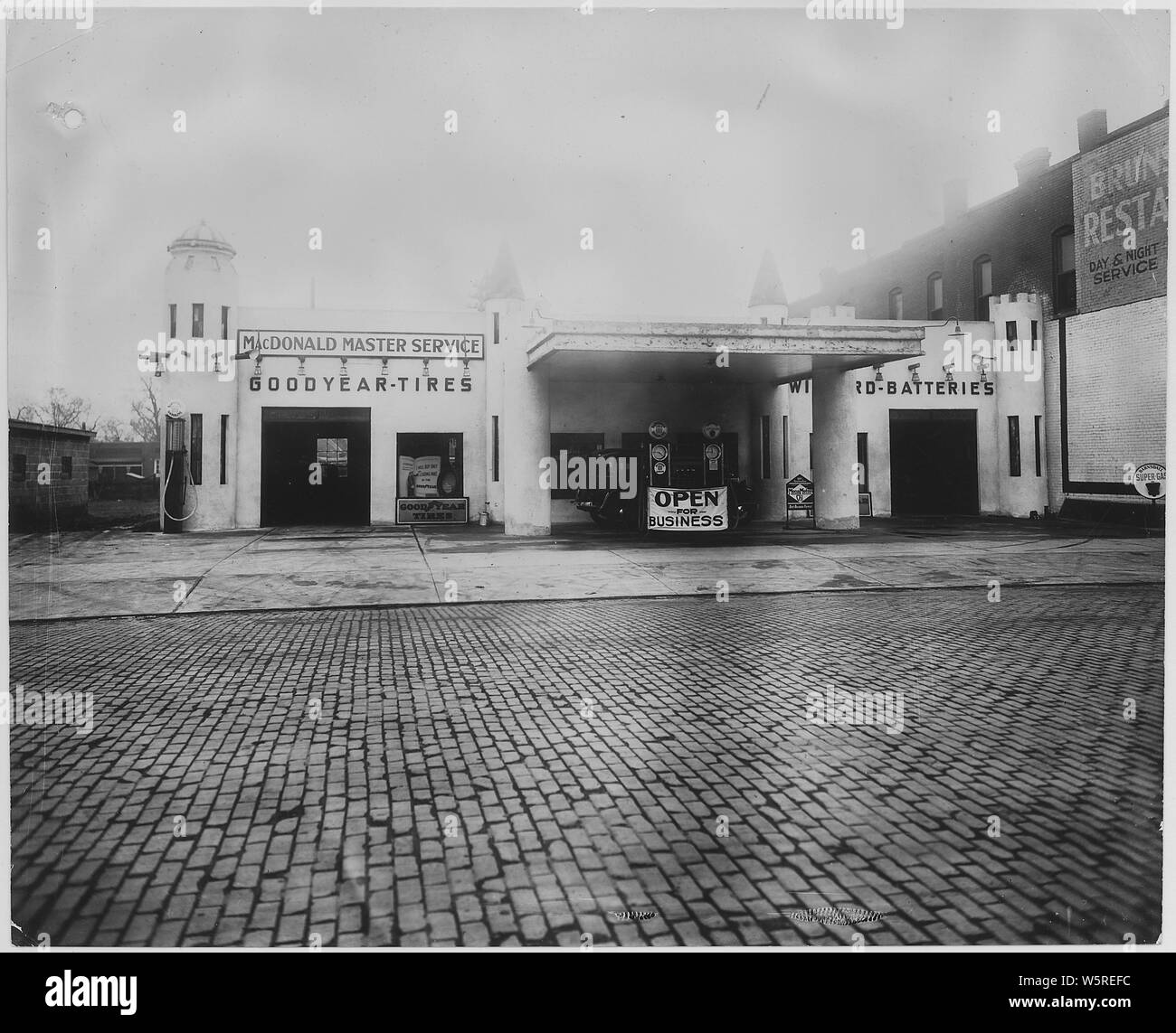 McDonald Master Service station. Omaha; Scope and content:  McDonald sold Goodyear tires. Brick street in front. Stock Photo