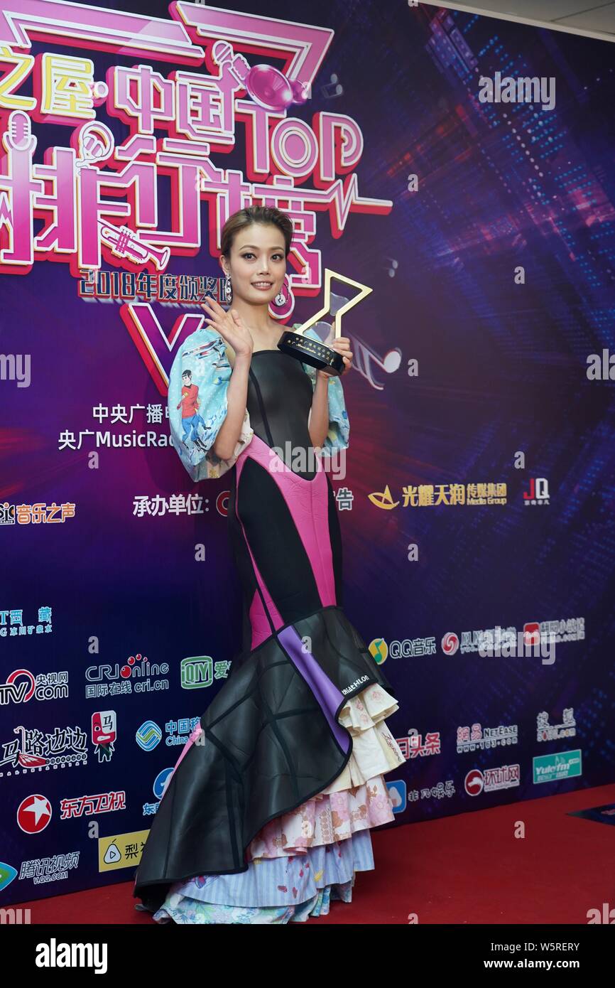 Hong Kong singer and actress Joey Yung poses with her trophy after