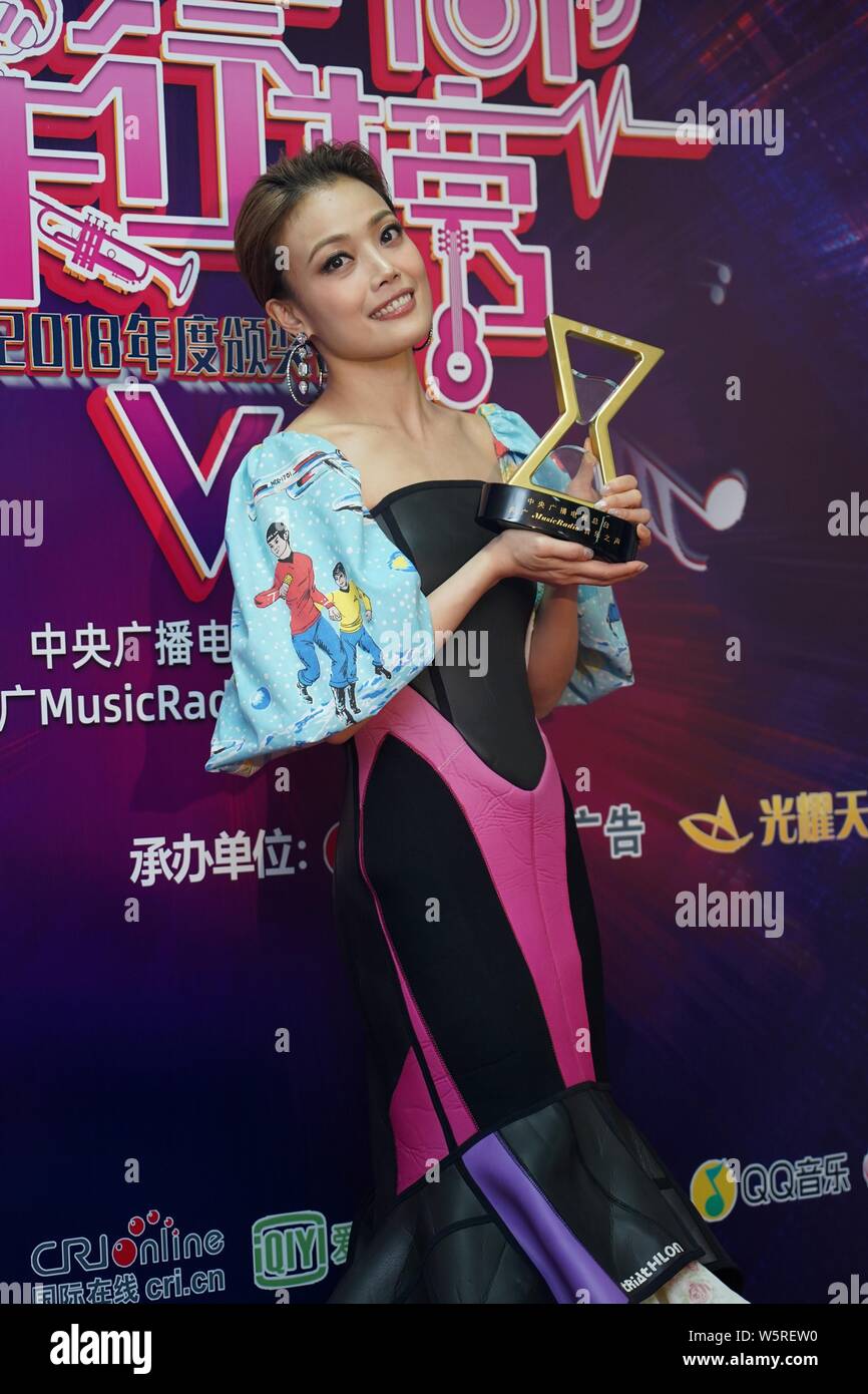 Hong Kong singer and actress Joey Yung poses with her trophy after
