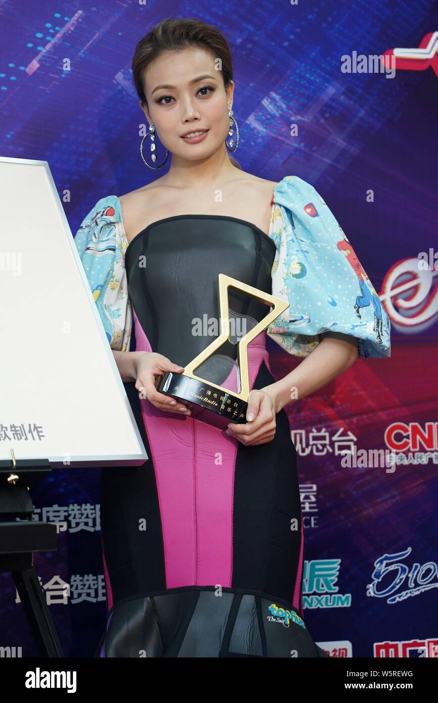 Hong Kong singer and actress Joey Yung poses with her trophy after