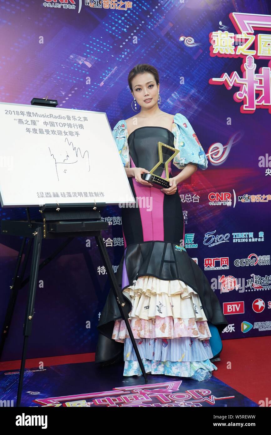 Hong Kong singer and actress Joey Yung poses with her trophy after