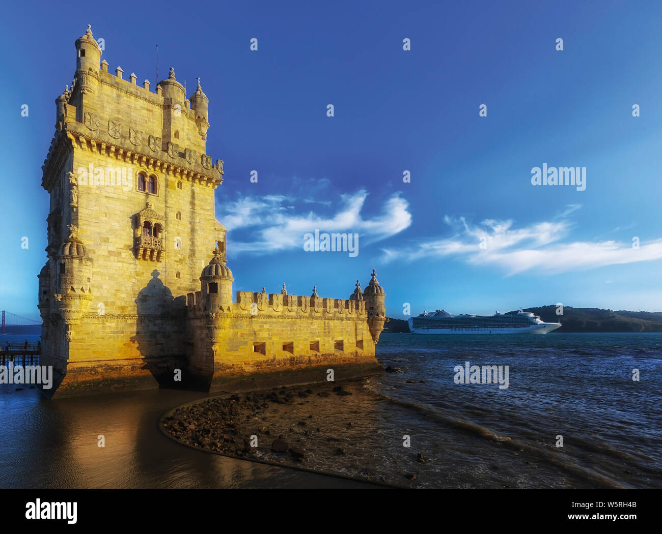 Lisbon, Portugal.  Cruise ship behind the 16th century Torre de Belem.  The tower is an important example of Manueline architecture and a UNESCO World Stock Photo