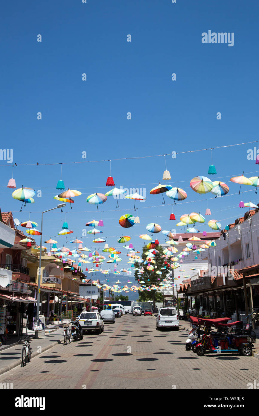 Celebratory brollies suspended above a street in Icmeler, Mugla province, Turkey. Stock Photo