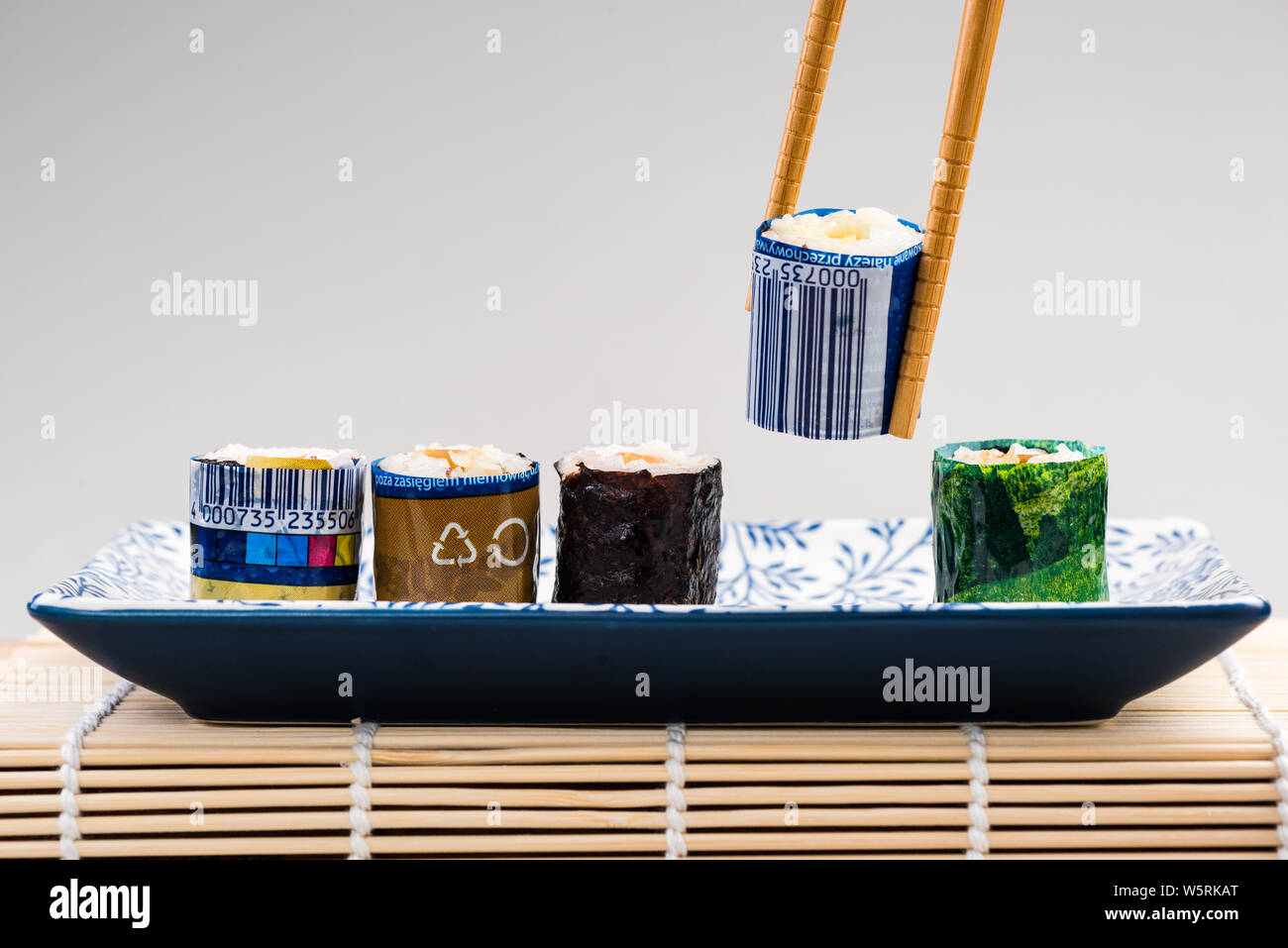 Sushi Wrapped in Plastic, Ocean Pollution Conceptual Image. Copy Space Poster. Stock Photo