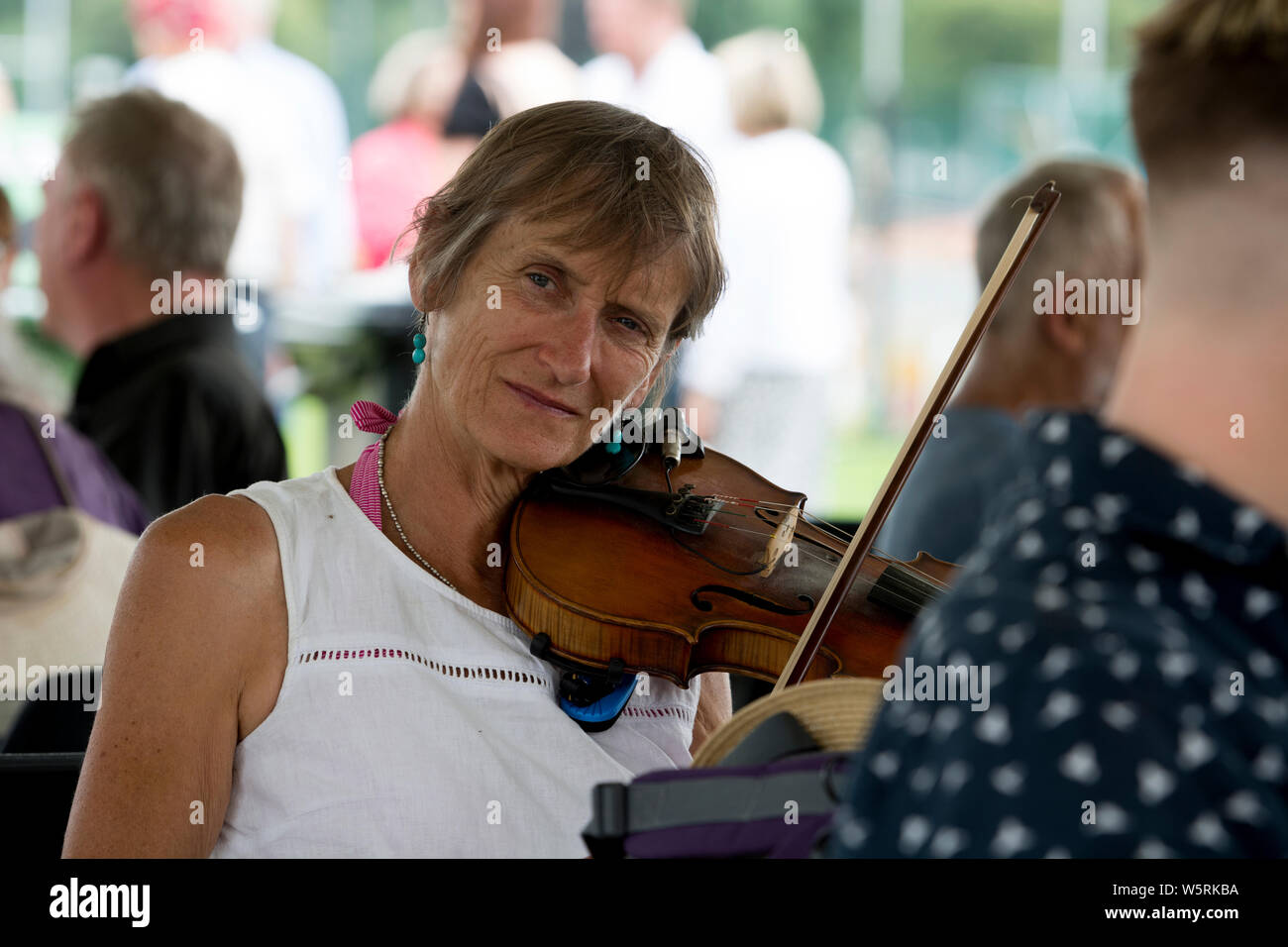 A woman playing a fiddle at Warwick Folk Festival, Warwickshire, UK Stock Photo