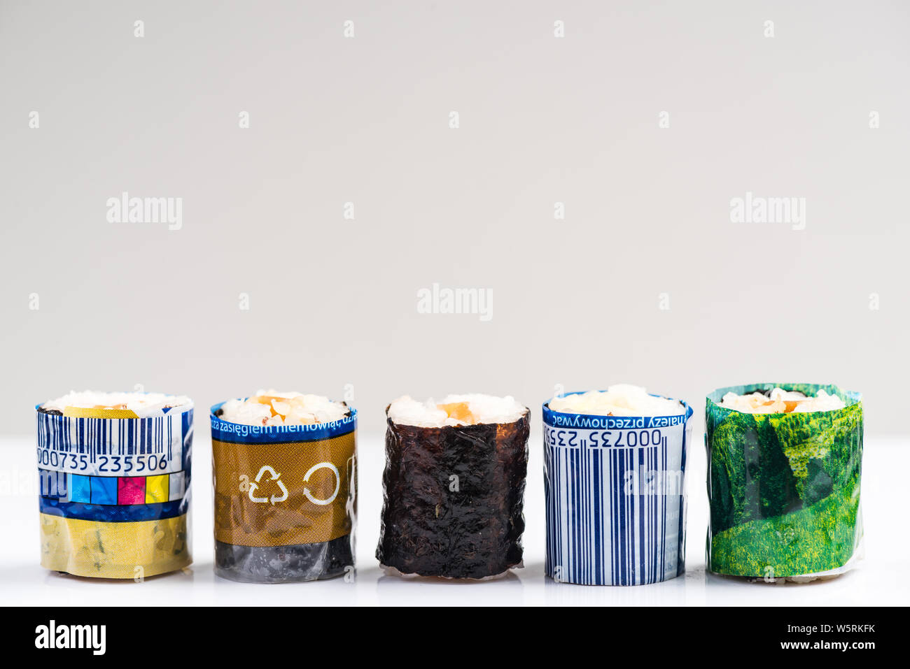 Sushi Wrapped in Plastic. Ocean Pollution And Environmental Conservation Concept. Stock Photo