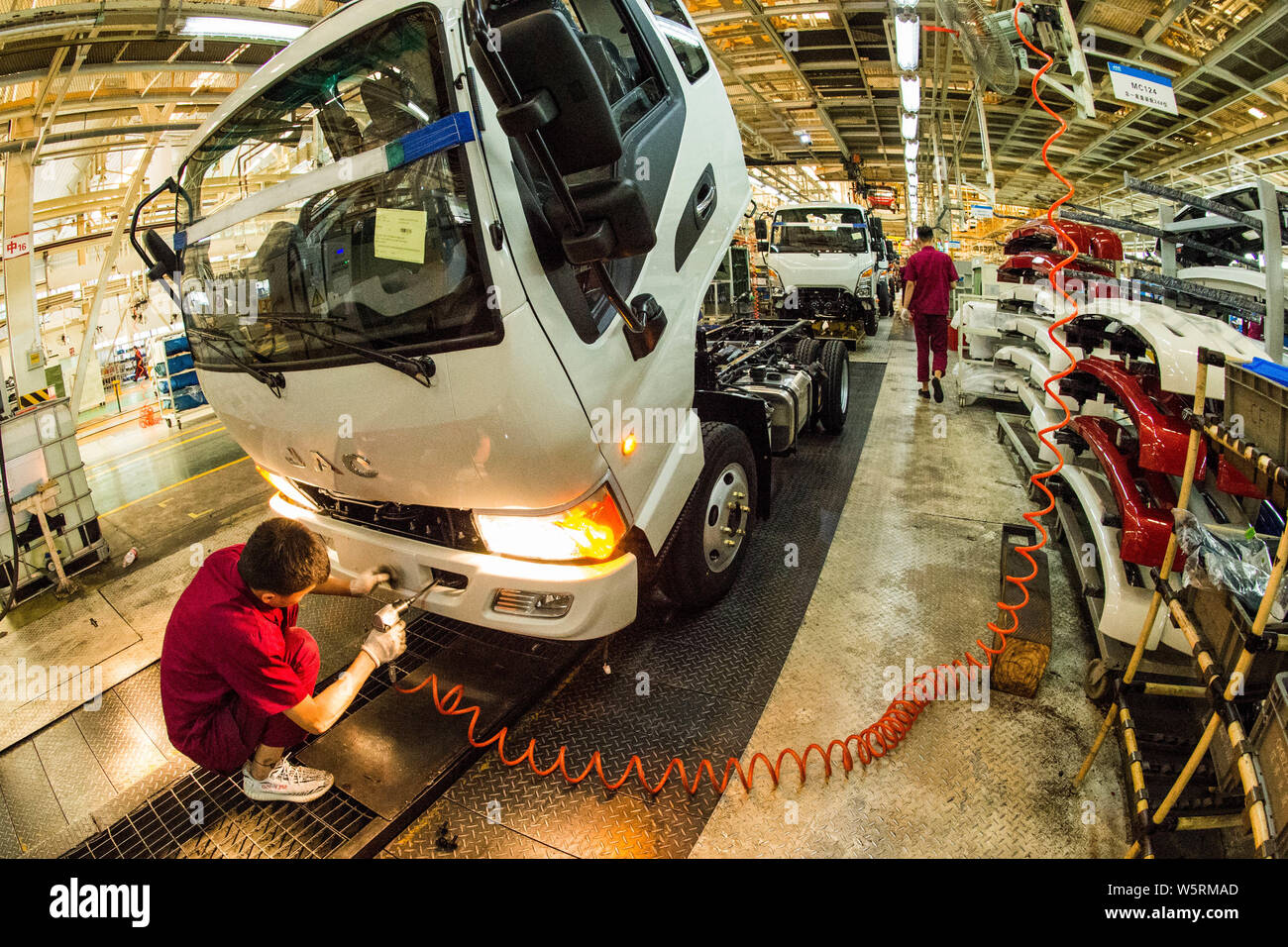 Chinese workers assemble vehicles on the assembly line at the auto ...