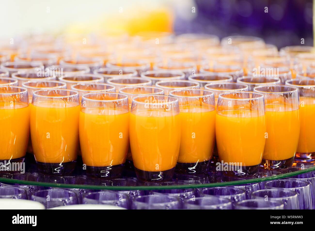 Orange juice in glass cups, refreshing alcohol-free beverages in