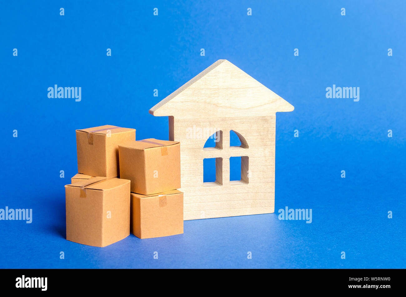 Living house and pile of boxes. Concept of moving to another house or city. beginning of a new stage of life. Property transportation. Freight shippin Stock Photo