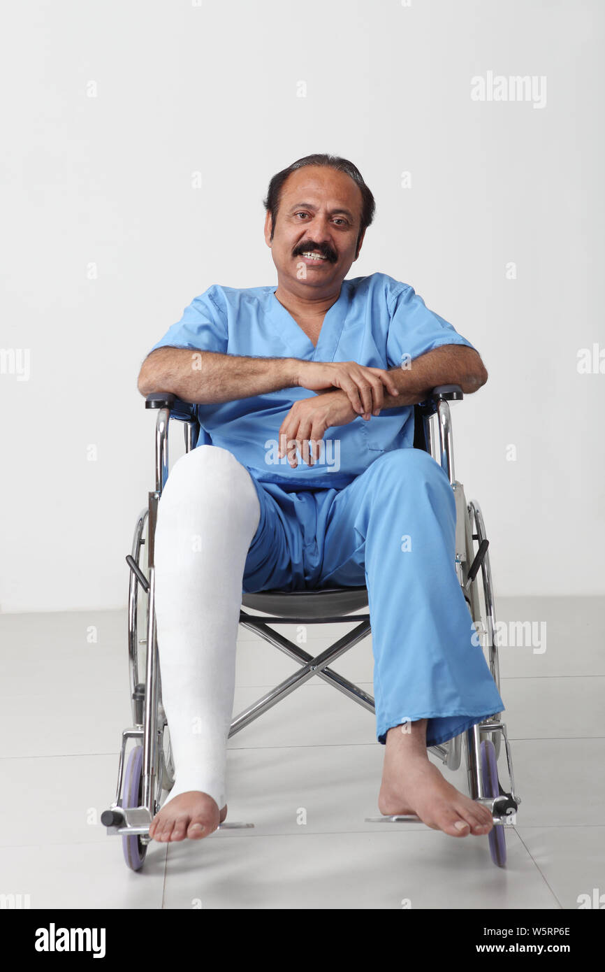 Portrait of a man with broken leg sitting in wheelchair Stock Photo Alamy
