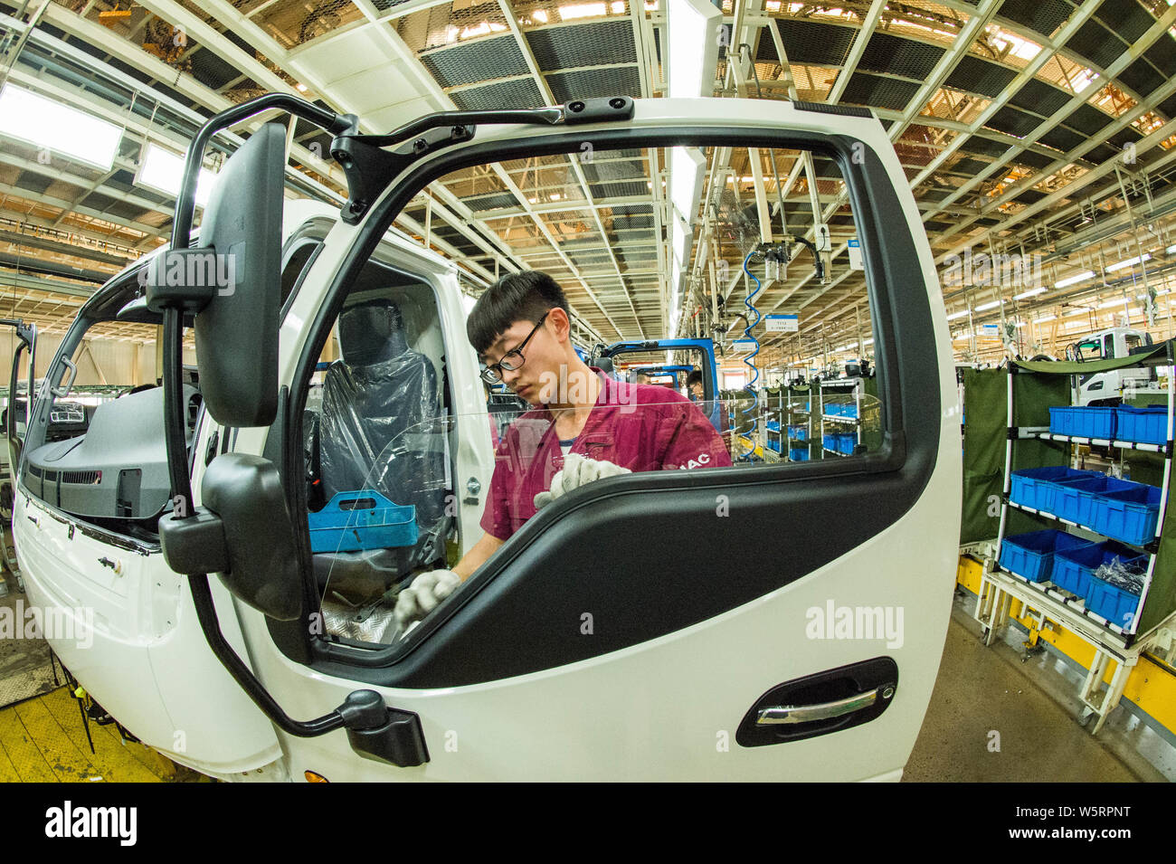 Chinese workers assemble vehicles on the assembly line at the auto ...