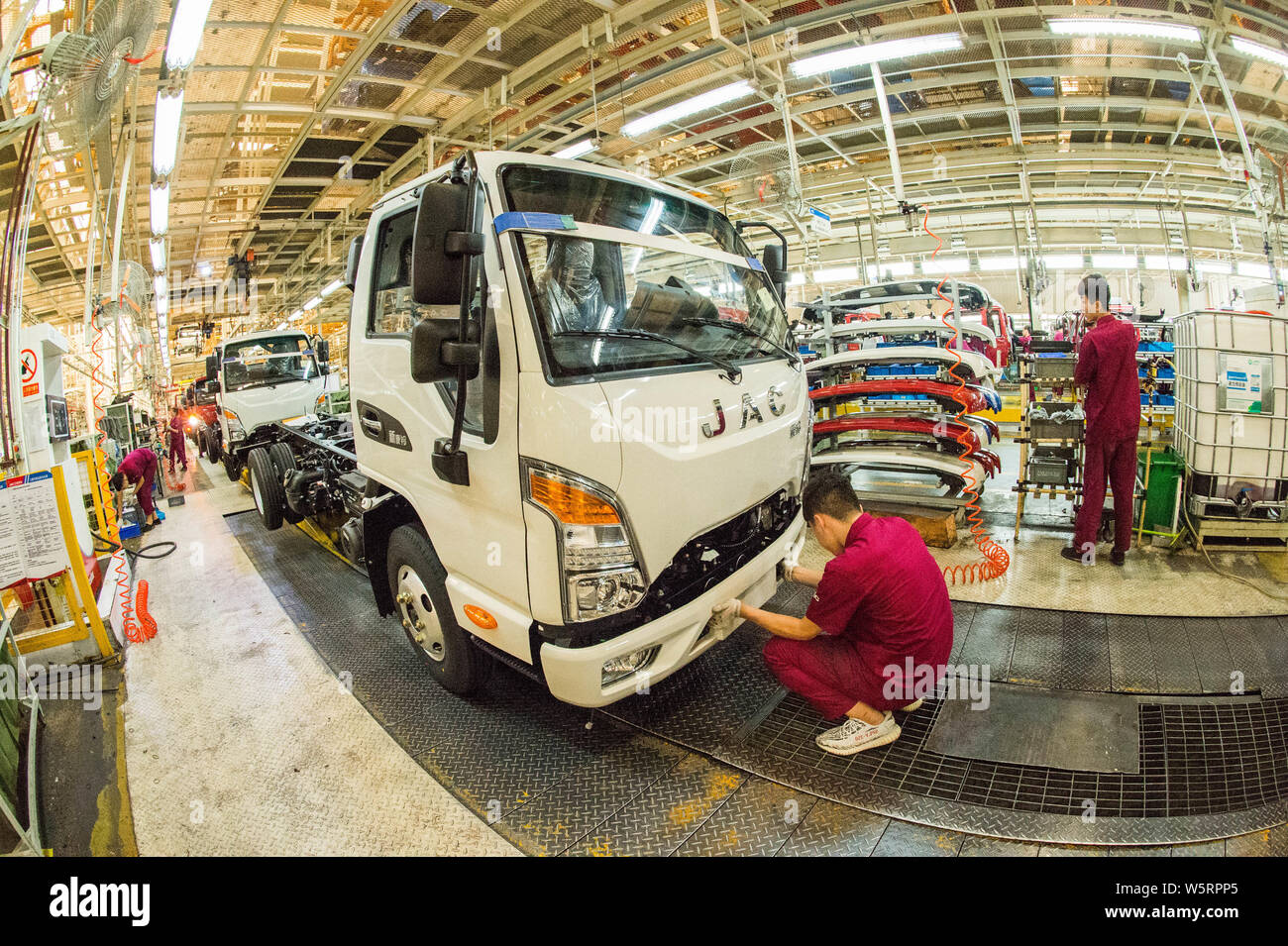 Chinese workers assemble vehicles on the assembly line at the auto ...