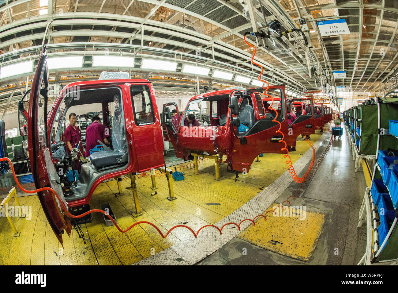 Chinese workers assemble vehicles on the assembly line at the auto ...