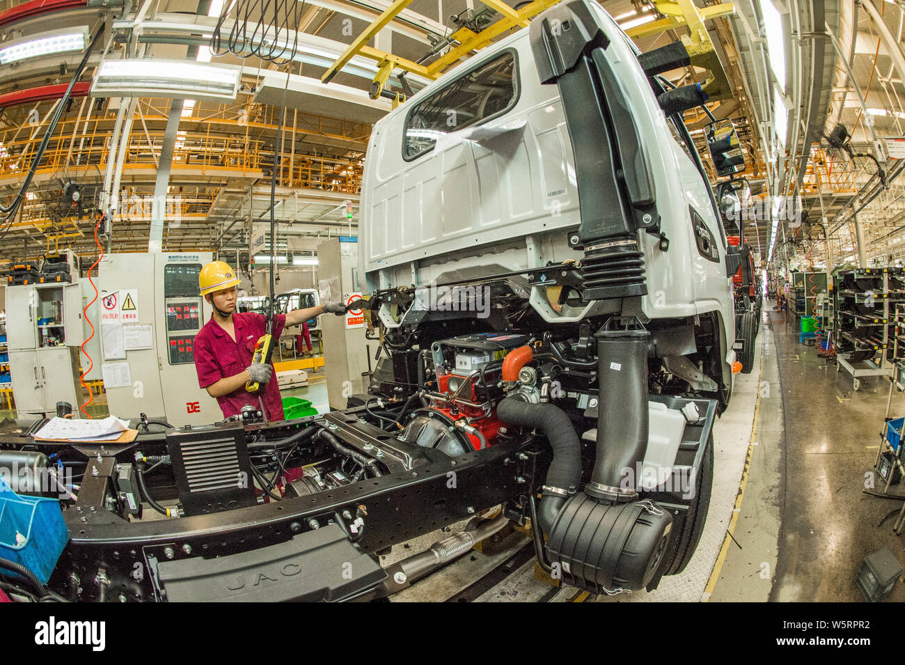 Chinese workers assemble vehicles on the assembly line at the auto ...