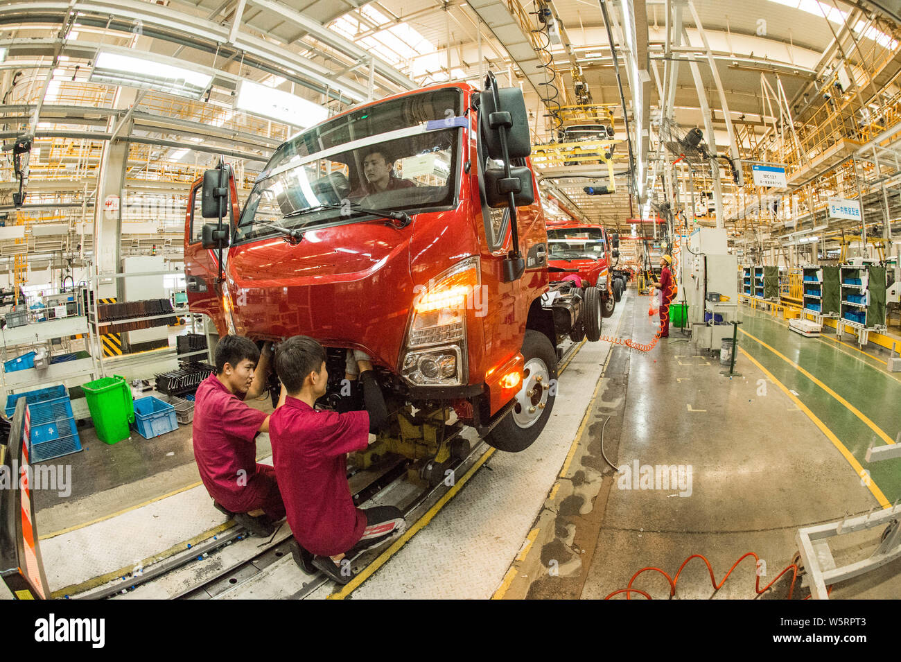Chinese workers assemble vehicles on the assembly line at the auto ...