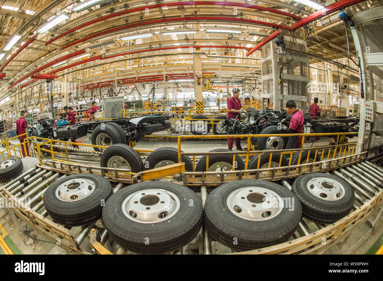 Chinese workers assemble vehicles on the assembly line at the auto ...