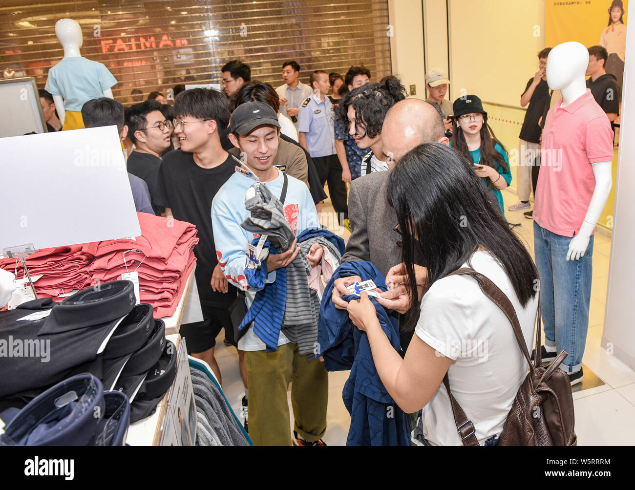 Chinese customers queue up in front of a Uniqlo store to buy the special KAWS  x Uniqlo UT collaborative capsule in Jinhua city, east China's Zhejiang  Stock Photo - Alamy