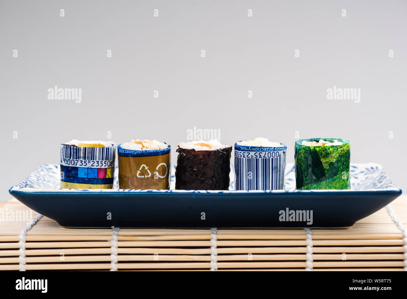 Sushi Wrapped in Plastic, Ocean Pollution Conceptual Image. Copy Space Poster. Stock Photo