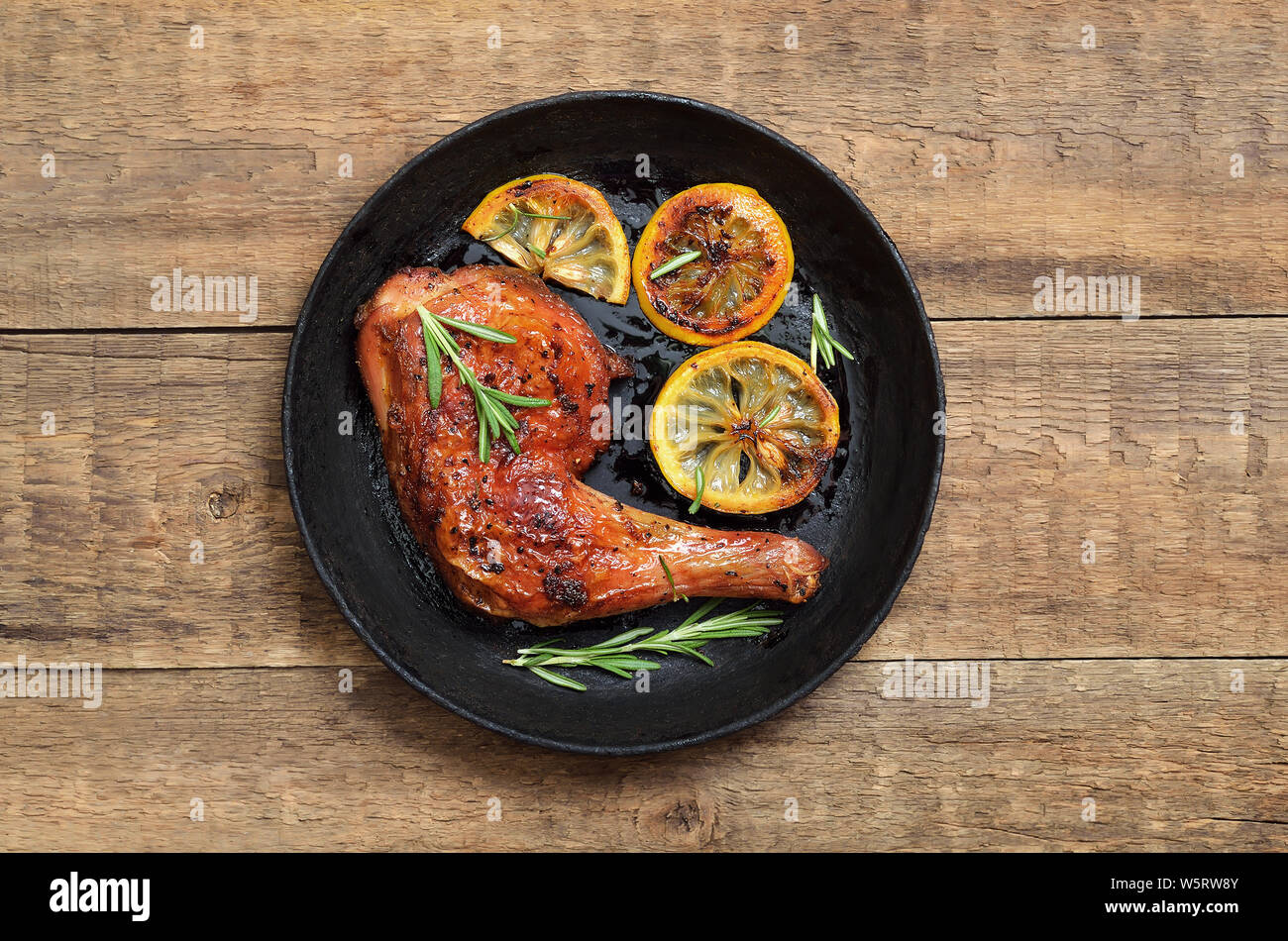 Appetizer grilled chicken leg in frying pan, top view Stock Photo Alamy