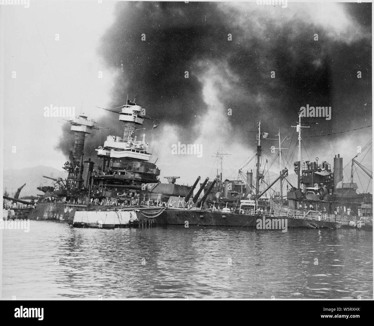 Naval photograph documenting the Japanese attack on Pearl Harbor, Hawaii which initiated US participation in World War II. Navy's caption: The sunken battleship USS CALIFORNIA after being hit by the Japanese during their sneak attack on Pearl Harbor on Dec. 7, 1941.; Scope and content:  This photograph was originally taken by a Naval photographer immediately after the Japanese attack on Pearl Harbor, but came to be filed in a writ of application for habeas corpus case (number 298) tried in the US District Court, District of Hawaii in 1944. The case, In Re Lloyd C. Duncan related to imposition Stock Photo