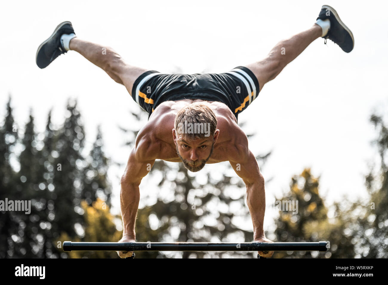 calisthenics hand stand fitness sport training and lifestyle concept young man exercising on parallel bars outdoors Stock Photo Alamy