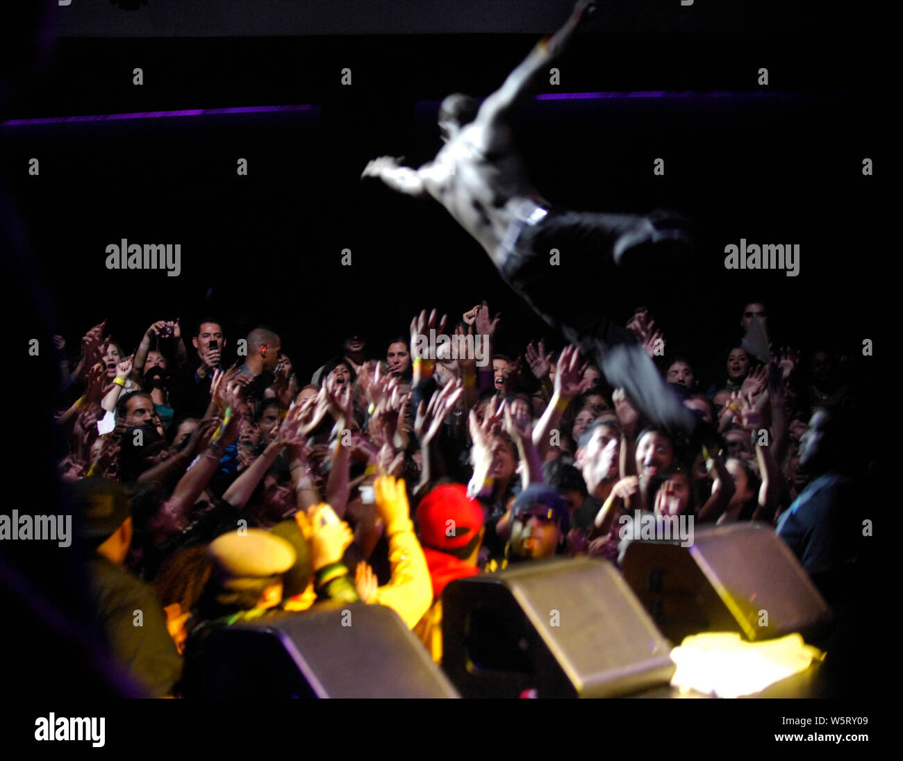 Singer Akon flys into a crowd of hands while he performs at the Nokia Theater LA Live in Los Angeles. Stock Photo