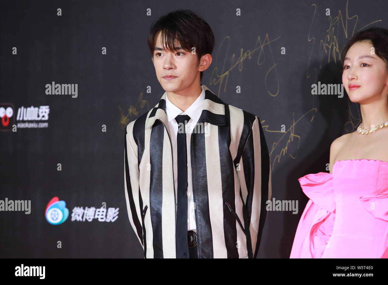 Jackson Yee or Yi Yangqianxi of Chinese boy group TFBoys, left, and Chinese  actress Zhou Dongyu arrive on the red carpet for 2019 Sina Weibo Film Night  in Shanghai, China, 16 June