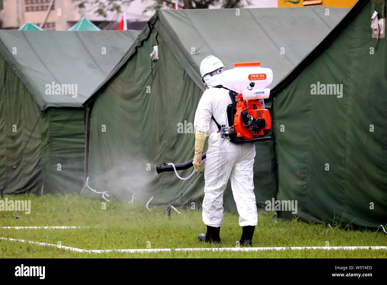 A Chinese Medical Worker Sprays Disinfectant On The Temporary Rescue Tents For Local Residents After The 6 0 Magnitude Earthquake In Shuanghe Town Ch Stock Photo Alamy