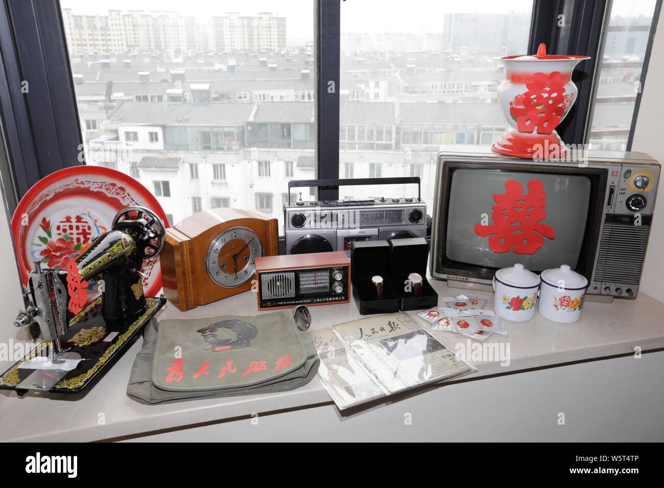 An old-fashioned radio, a sewing machine, wrist watches and other items are displayed during a wedding ceremony in Suzhou city, east China's Jiangsu p Stock Photo