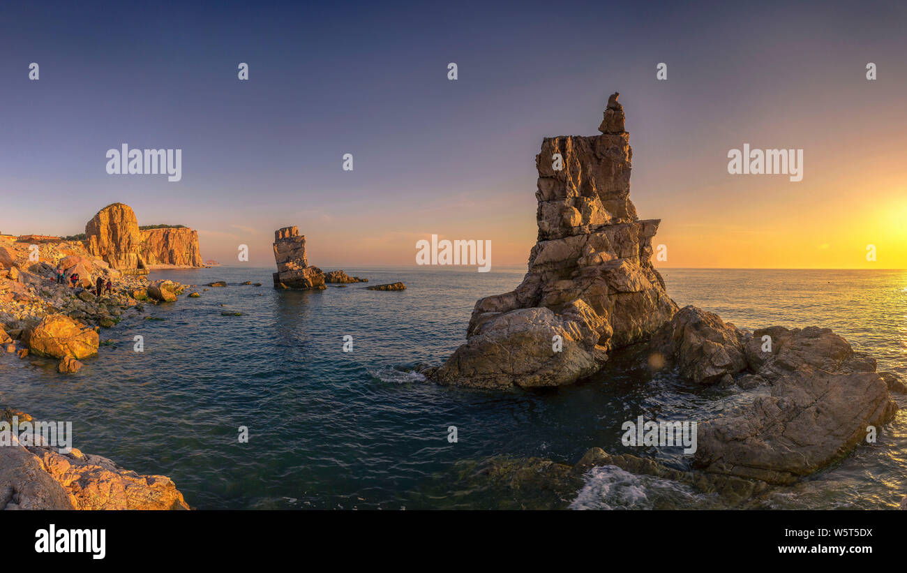 Landscape of the Jiangjunshi Scenic Zone, which is famous for its coastal landforms, at sunset in Dalian city, northeast China's Liaoning province, 31 Stock Photo