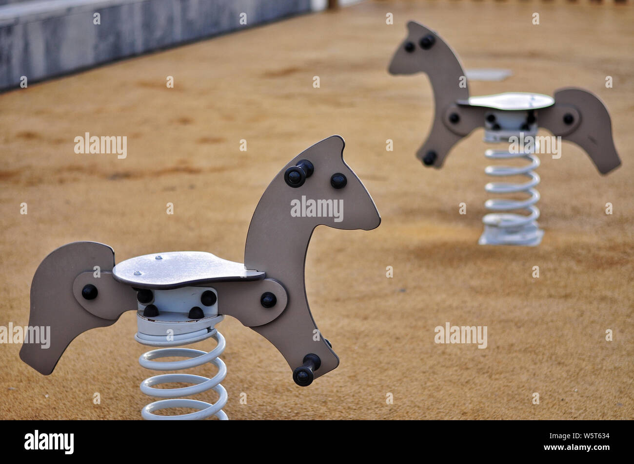 Brown horse swings. A bit nostalgic scenery of the kids playground Stock Photo