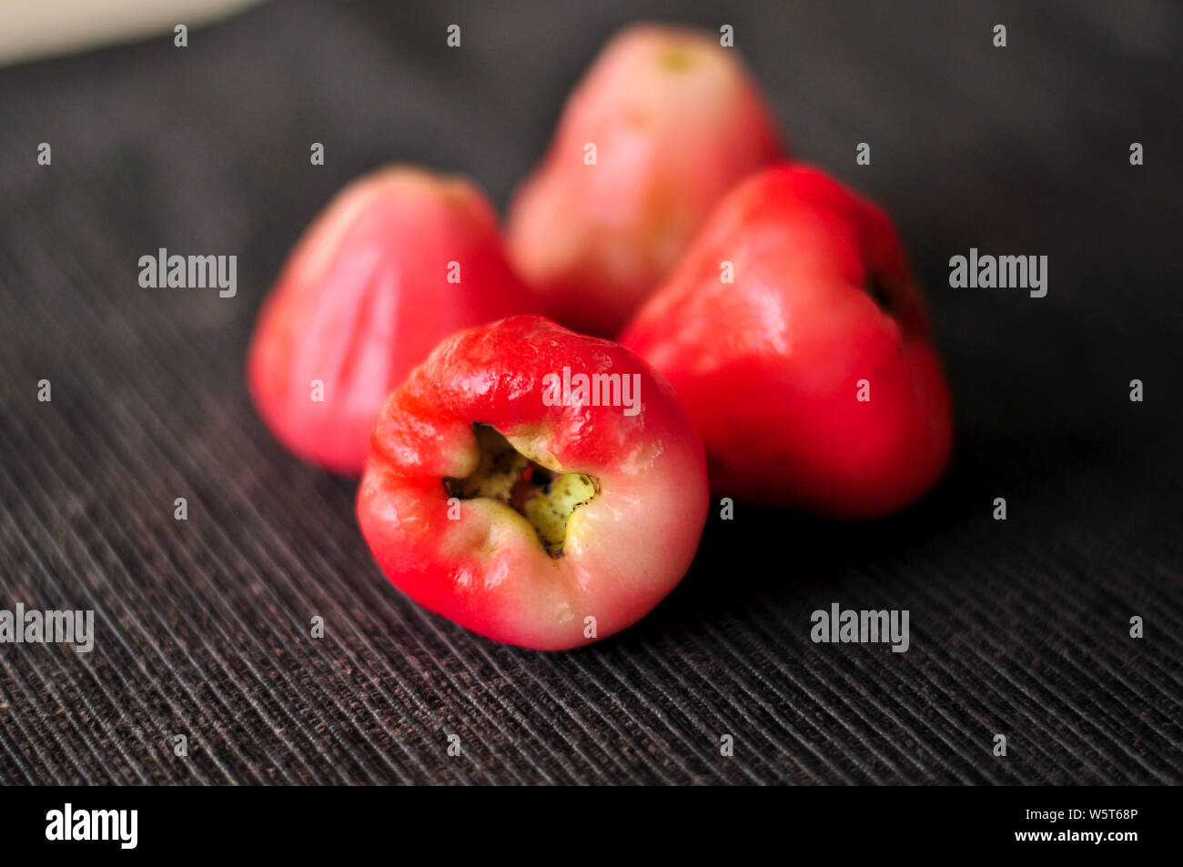 Rose Apple (wax apple) fruits close-up. Syzygium jambos is a tree originating in Southeast Asia and occurring widely elsewhere, having been introduced Stock Photo