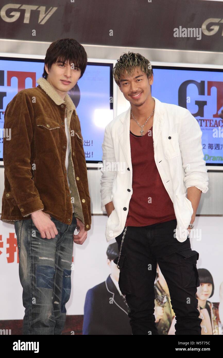 Japanese singer Ryohei Kurosawa, right, better known by the stage name Akira, of Japanese band EXILE, and actor Yu Shirota attend a press conference f Stock Photo