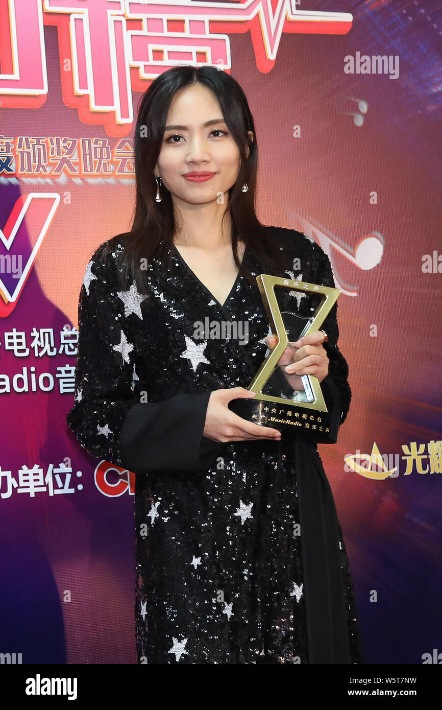 Chinese singer Liu Xijun poses with her trophy during the 2018 Music
