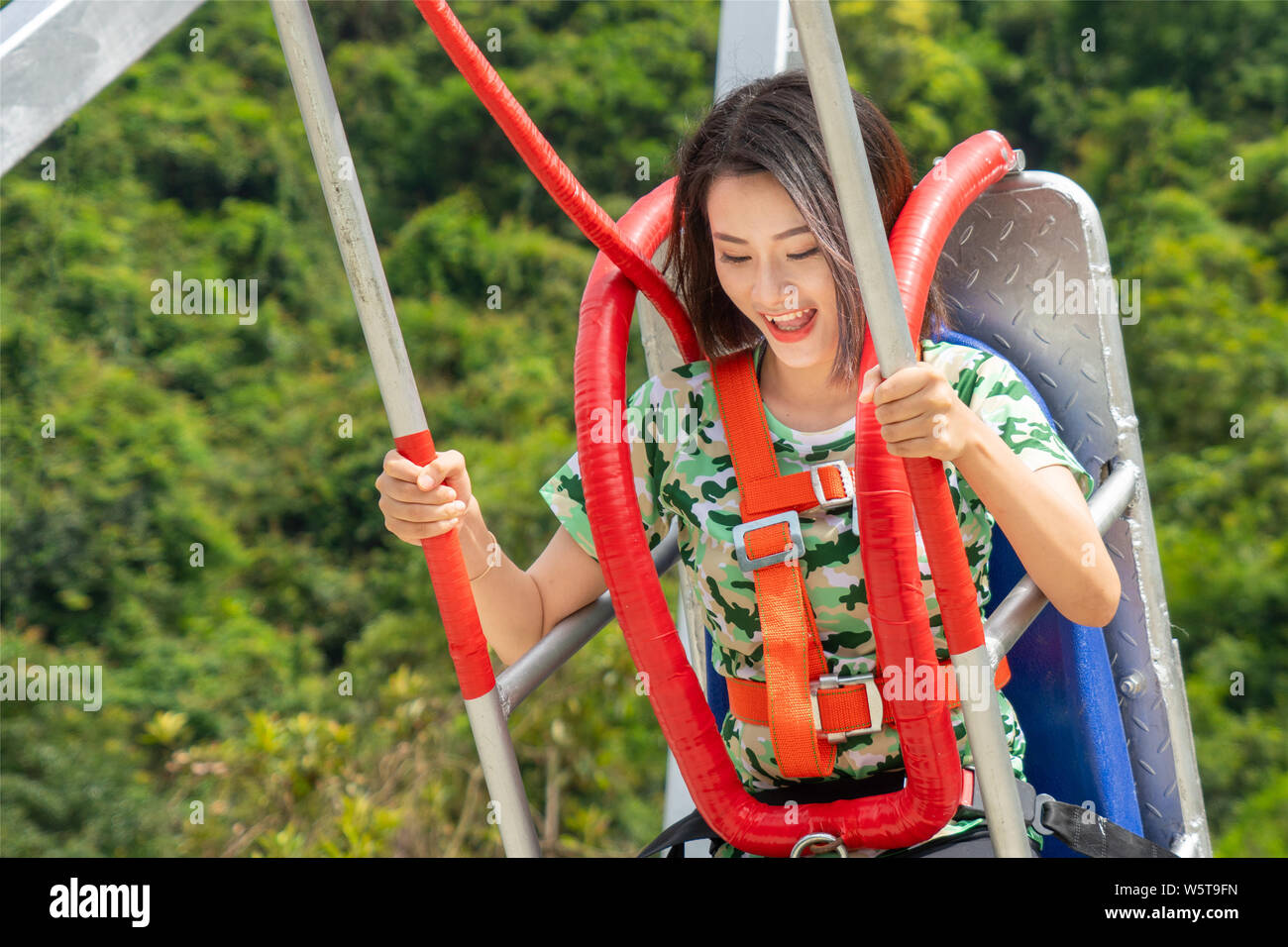 A visitor tries out 198-meter-high cliff swing, which is Guangdong's ...