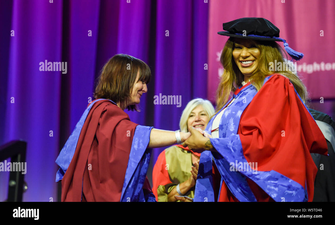Brighton UK 30th July 2019 - Famous transgender model Munroe Bergdorf after receiving an honorary doctor of letters at the University of Brighton graduation ceremony greets her lecturer Dr Jessica Moriarty . Credit : Simon Dack / Alamy Live News Stock Photo