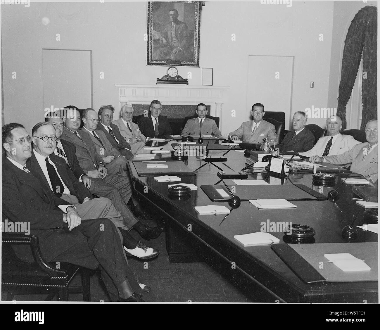 Photograph of Cabinet meeting at the White House: (from left to right) Secretary of Agriculture Clinton P. Anderson; Secretary of Labor Lewis Schwellenbach; John Blandford, Jr. of the National Housing Agency; Julius Krug of the War Production Board; John Snyder of the Office of War Mobilization and Reconversion; William H. Davis of the Office of Economic Stabilization; Leo T. Crowley of the Foreign Economic Administration; Secretary of Commerce Henry A. Wallace; Under Secretary of the Interior Abe Fortas; Postmaster General Robert Hannegan; Secretary of War Henry Stimson; Secretary of State Ja Stock Photo