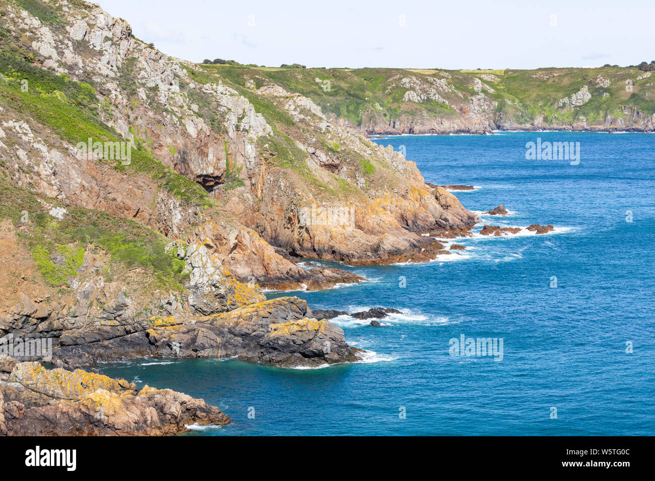 The view NE from the cliffs at Pointe de la Moye, Le Gouffre, Les Villets on the beautiful, rugged south coast of Guernsey, Channel Islands UK Stock Photo