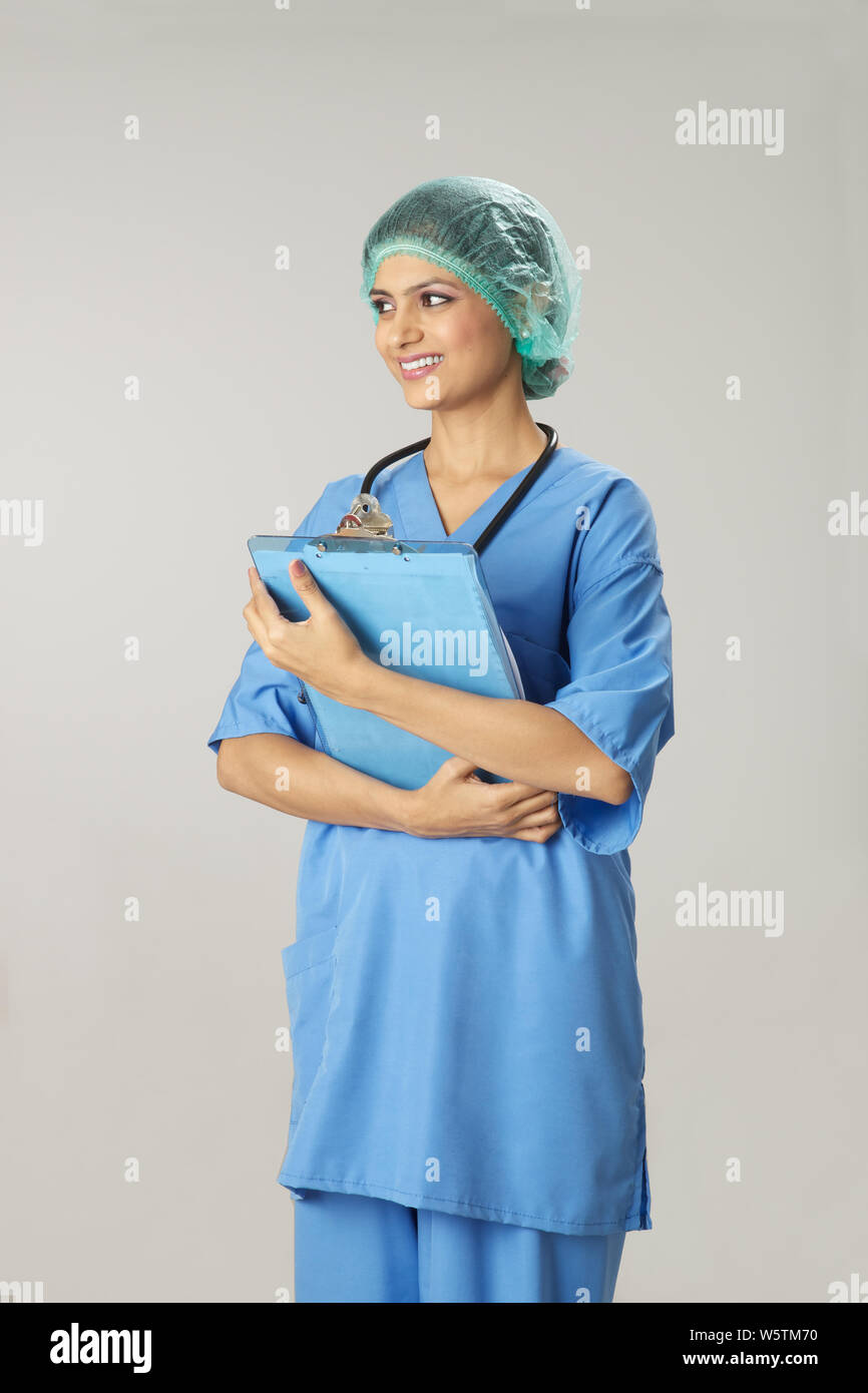 Indian female doctor holding medical report and smiling Stock Photo - Alamy