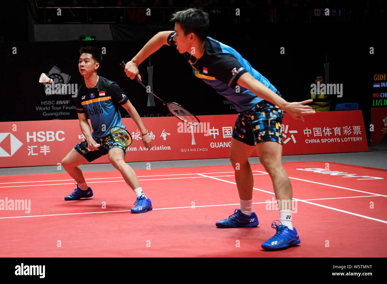 Marcus Fernaldi Gideon and Kevin Sanjaya Sukamuljo of Indonesia return a shot to Li Junhui and Liu Yunchen of China in their Mens Doubles Group B mat Stock Photo