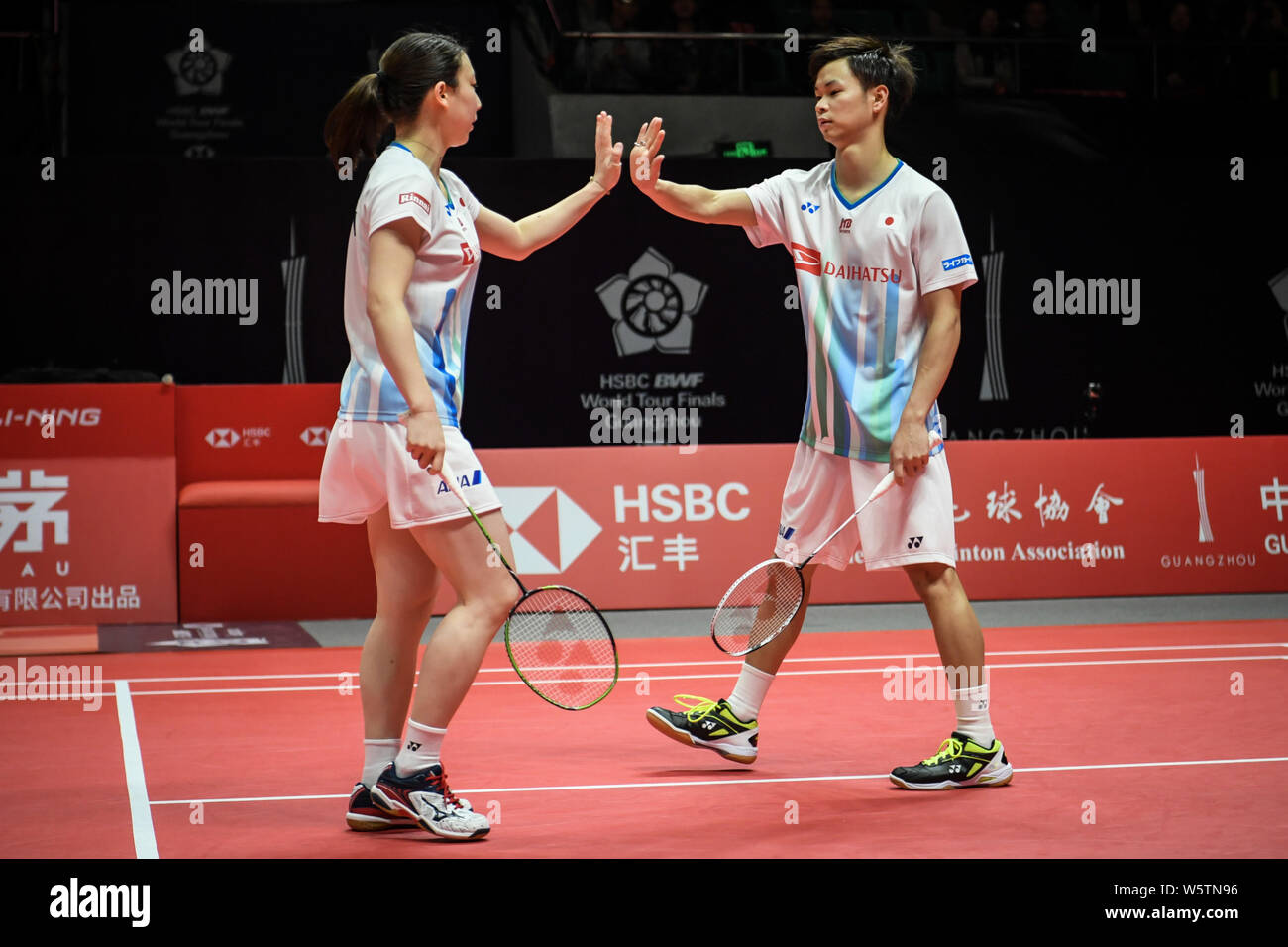 Yuta Watanabe and Arisa Higashino of Japan react after scoring against Hafiz Faizal and Gloria Emanuelle Widjaja of Indonesia in their Mixed Doubles G Stock Photo