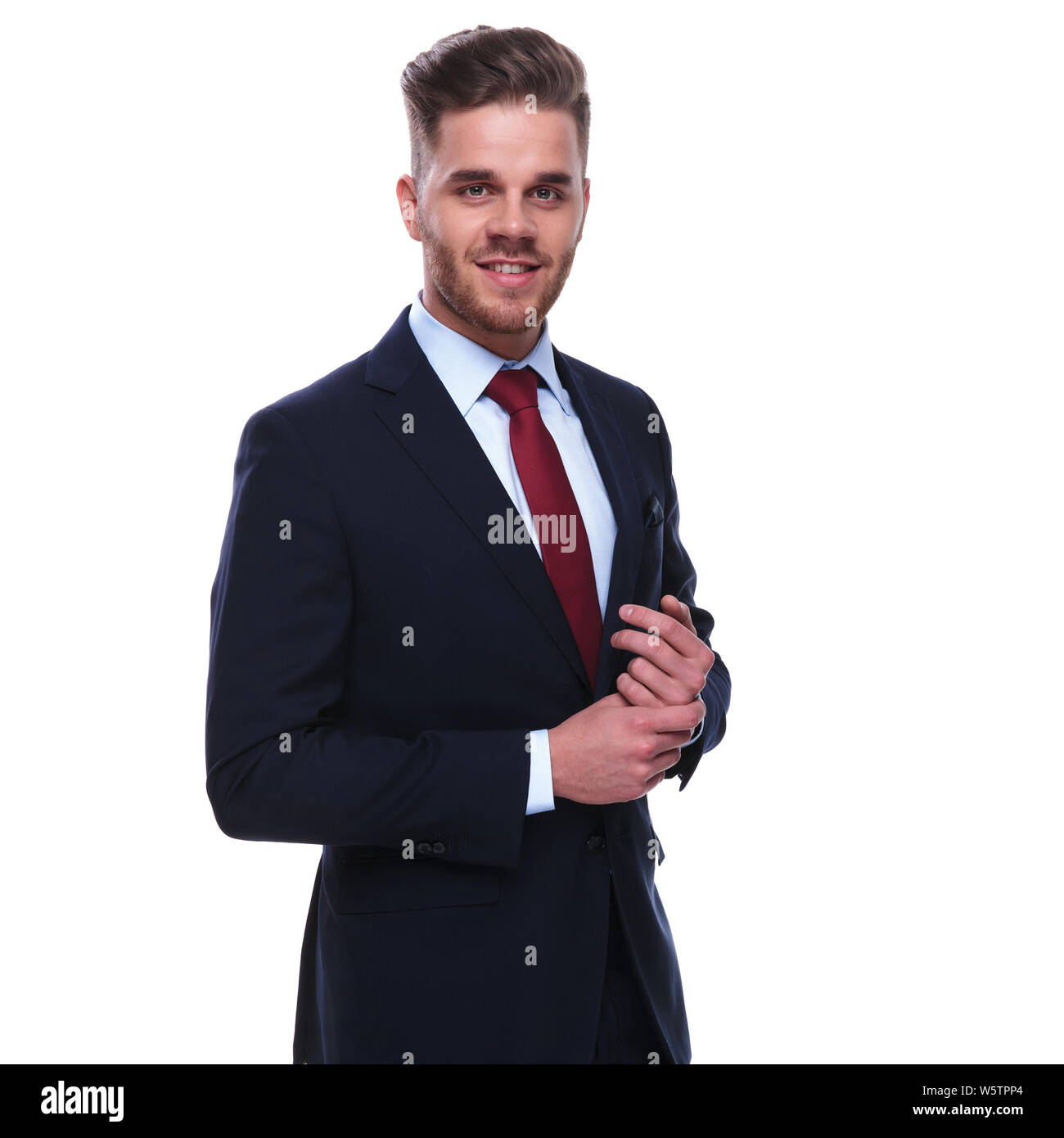 anker logo Fremragende portrait of smiling businessman in navy suit and red tie fixing his sleeves  while standing on white background Stock Photo - Alamy