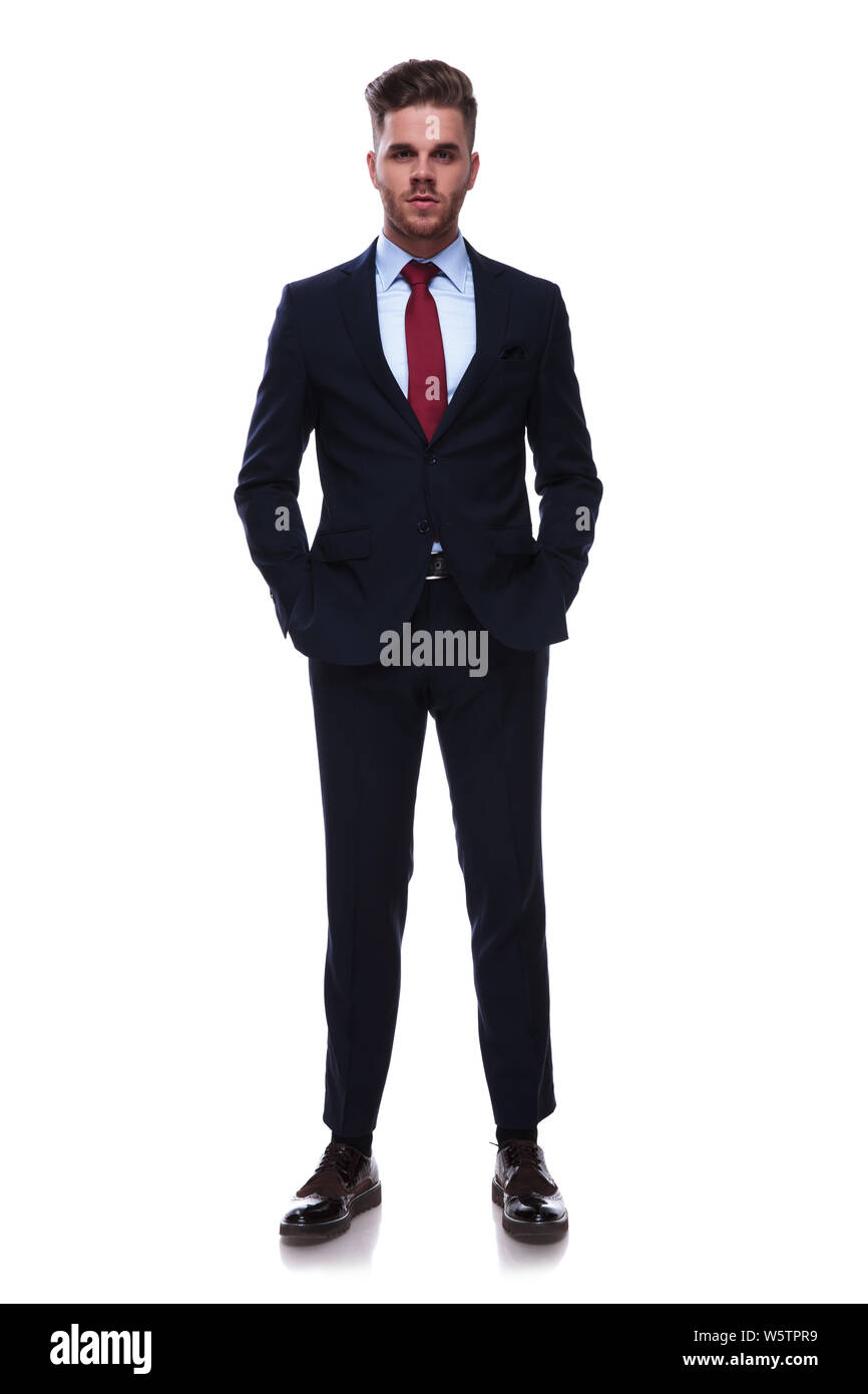 handsome relaxed businessman in navy colored suit standing on white ...