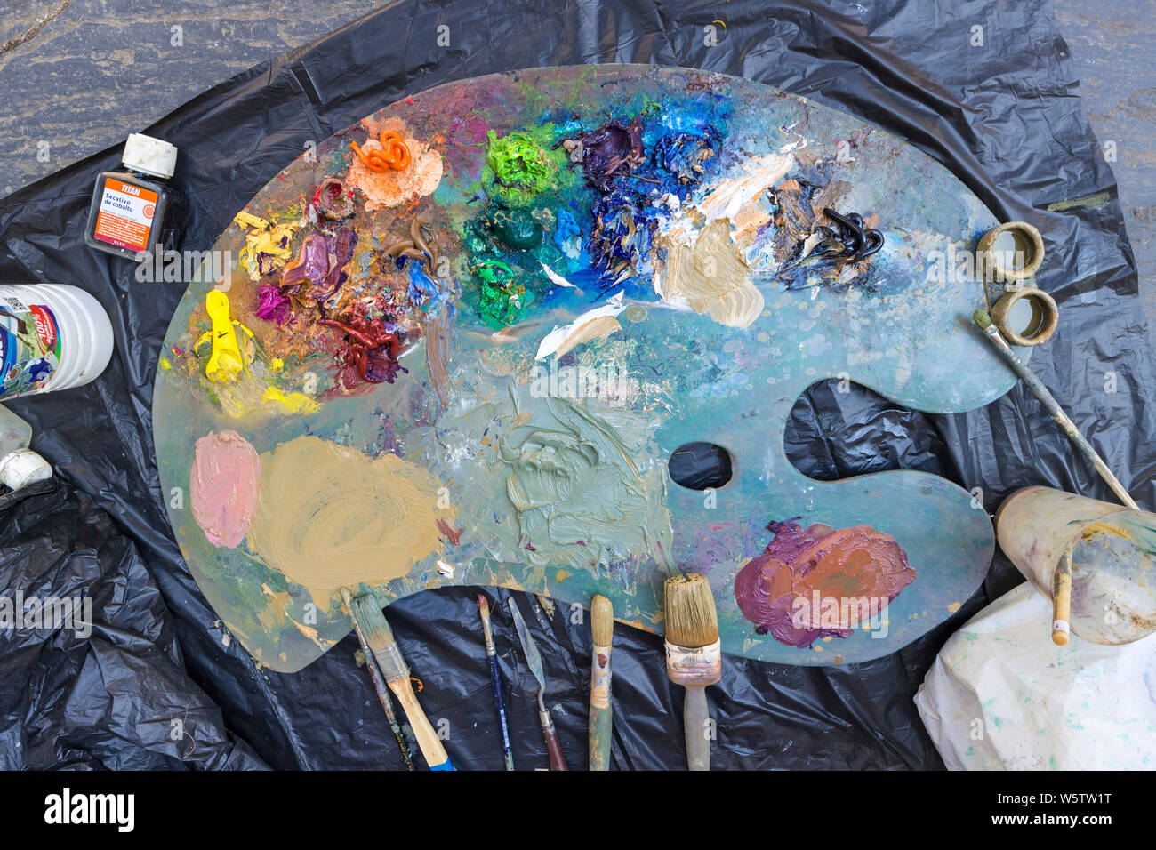 A Painter’s Palette with Paints and Brushes. Stock Photo
