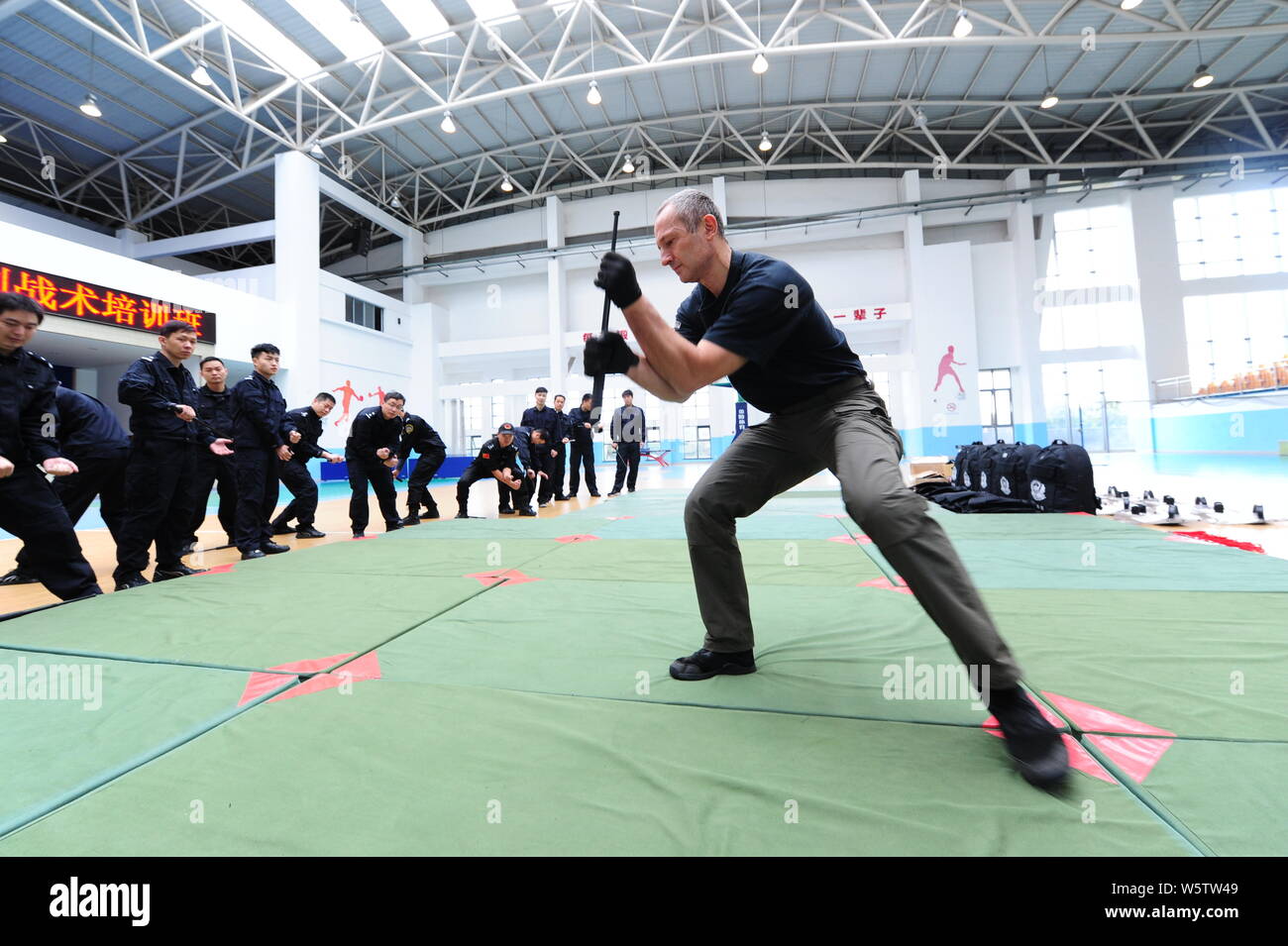 A Czech expert instructor demonstrates hand-to-hand combat to policemen during a specialist training in Taicang city, east China's Jiangsu province, 5 Stock Photo